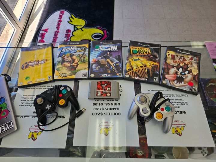 Gamecube controller, Gamecube games, and Nintendo 64 game being traded into 6R's entertainment yard.