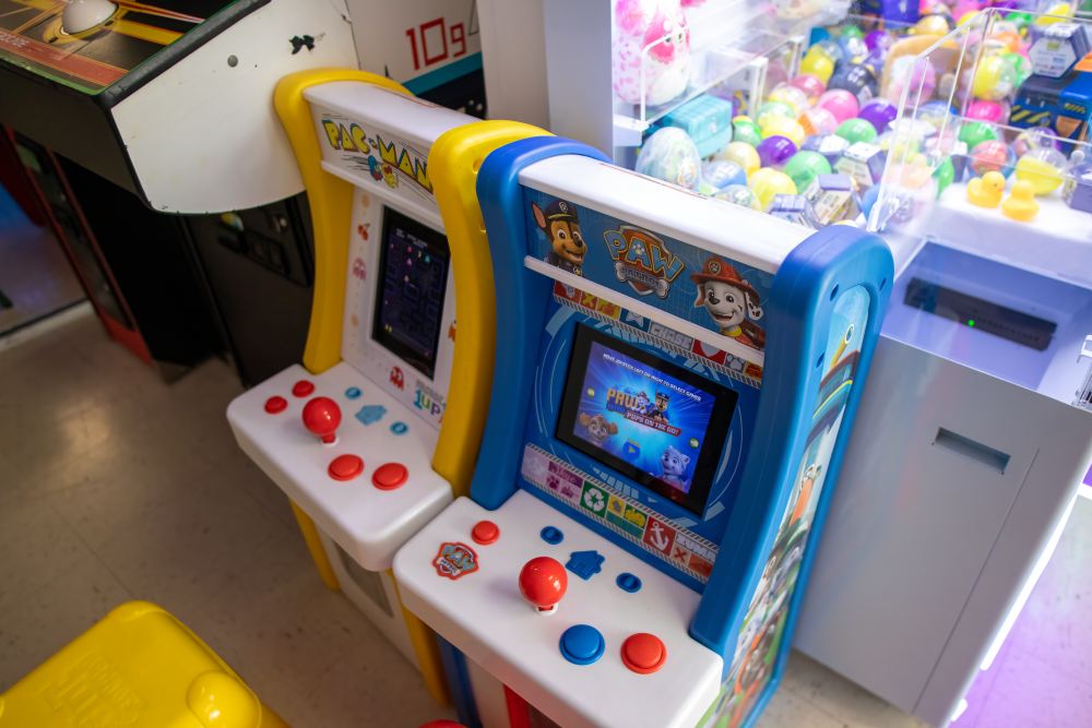 Small toddler sized arcade cabinets with Pac Man and a Paw Patrol game at 6R's entertainment yard