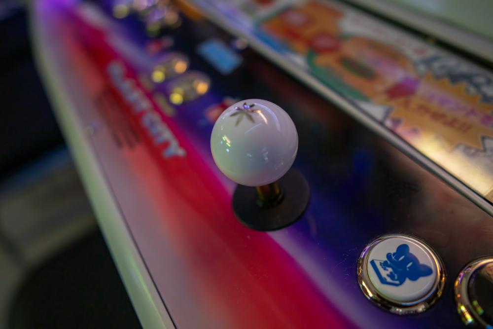 Low-angled shot of arcade stick and Lindy arcade cabinet at 6R's entertainment yard