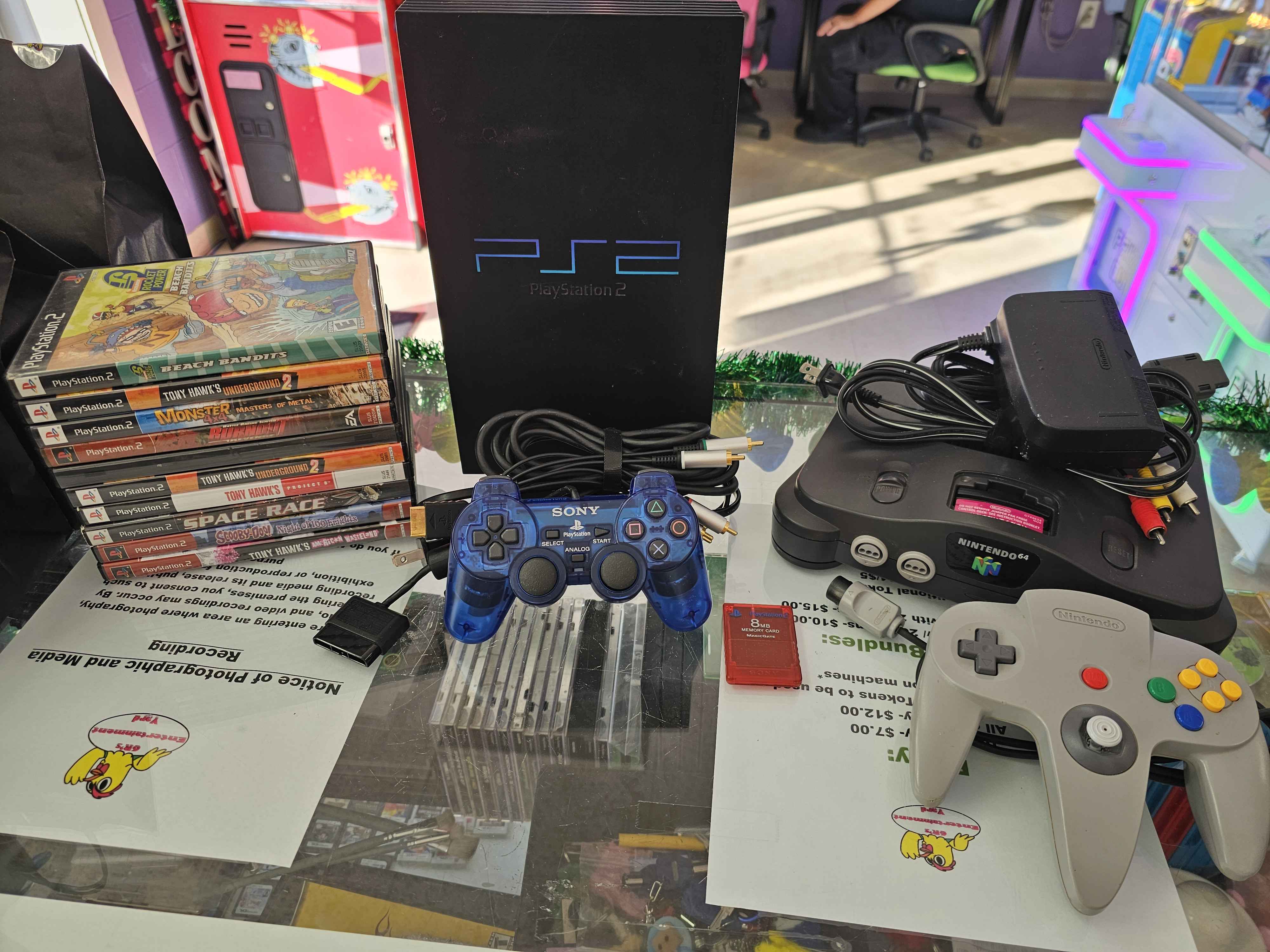 PS2 games, PS2 controllers, PS2 console, and Nintendo 64 console being traded into 6R's entertainment yard.