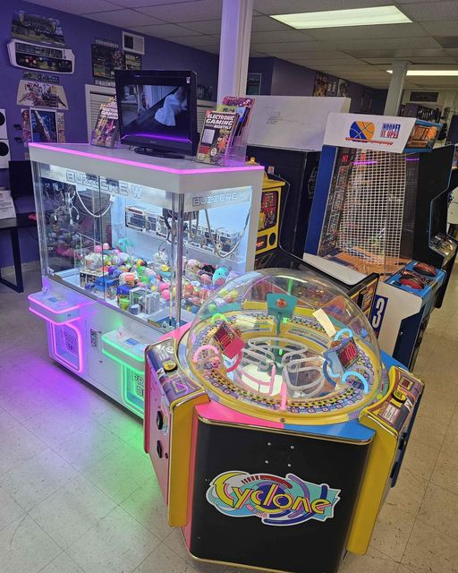 Claw machine, Cyclone redemption machine, and Hoop it Up shown at 6R's entertainment yard.